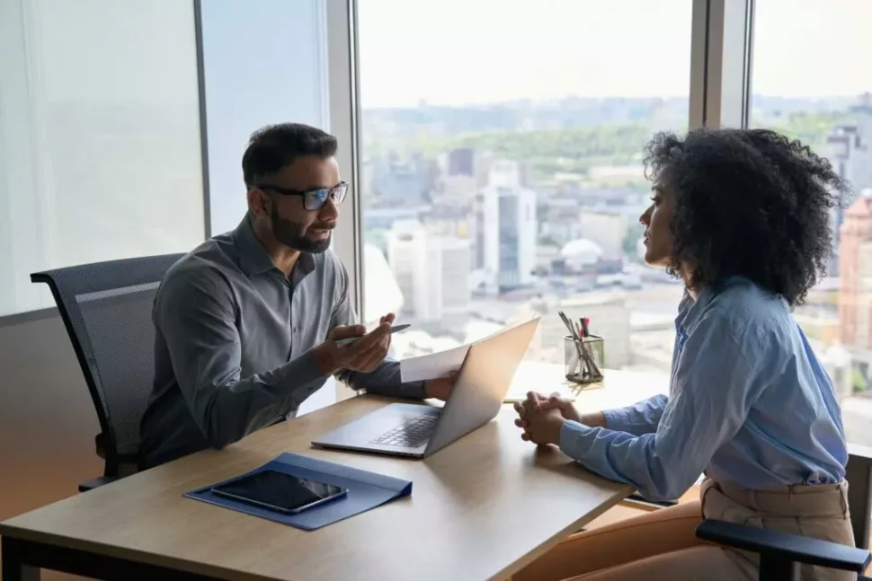 A man and woman meeting in an office for an hr review